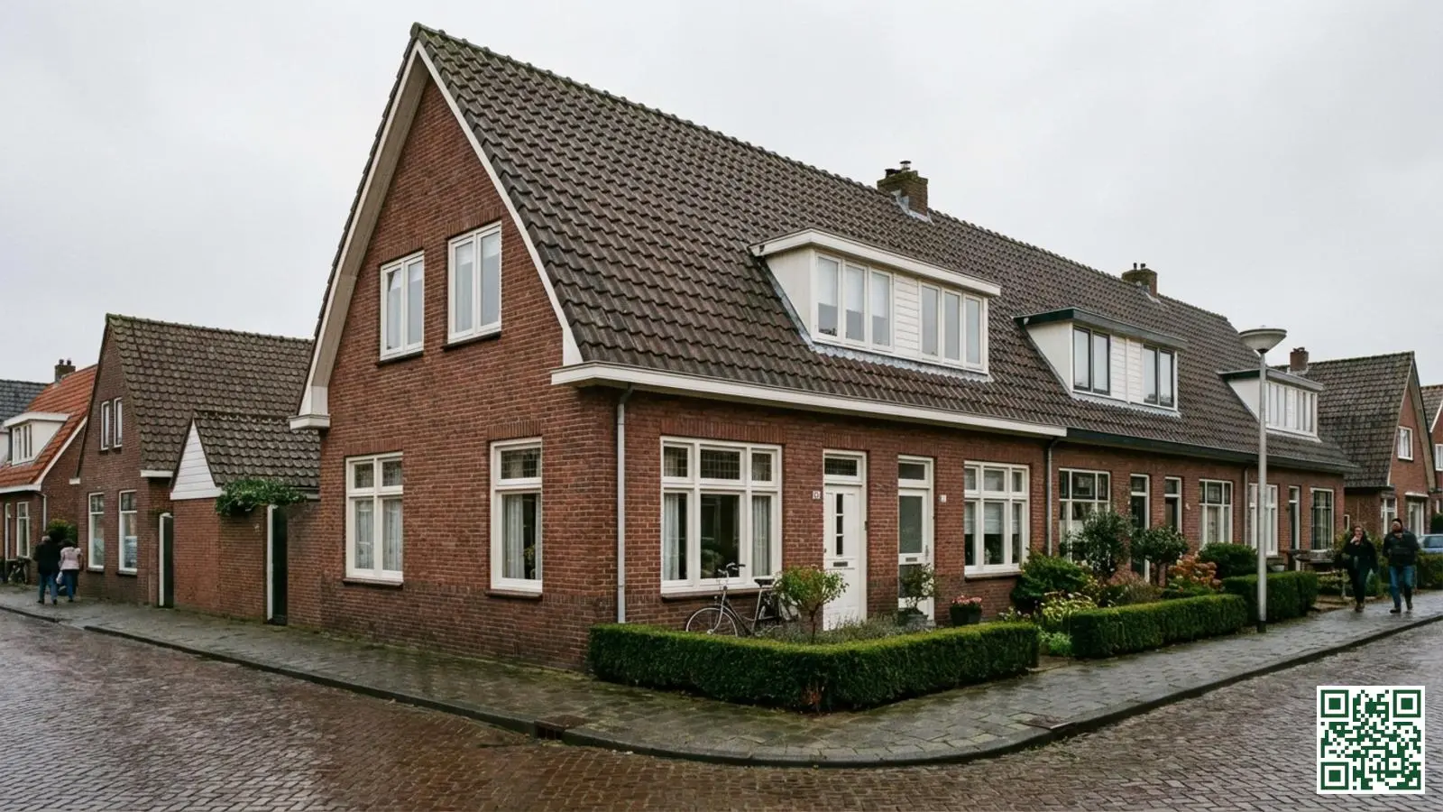 Nederlands rijtjeshuis met klassiek zadeldak van donkere dakpannen en rode bakstenen gevel